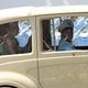 The new queen is seen with the king as their motorcade arrives at the Grand Palace in Bangkok for the coronation.